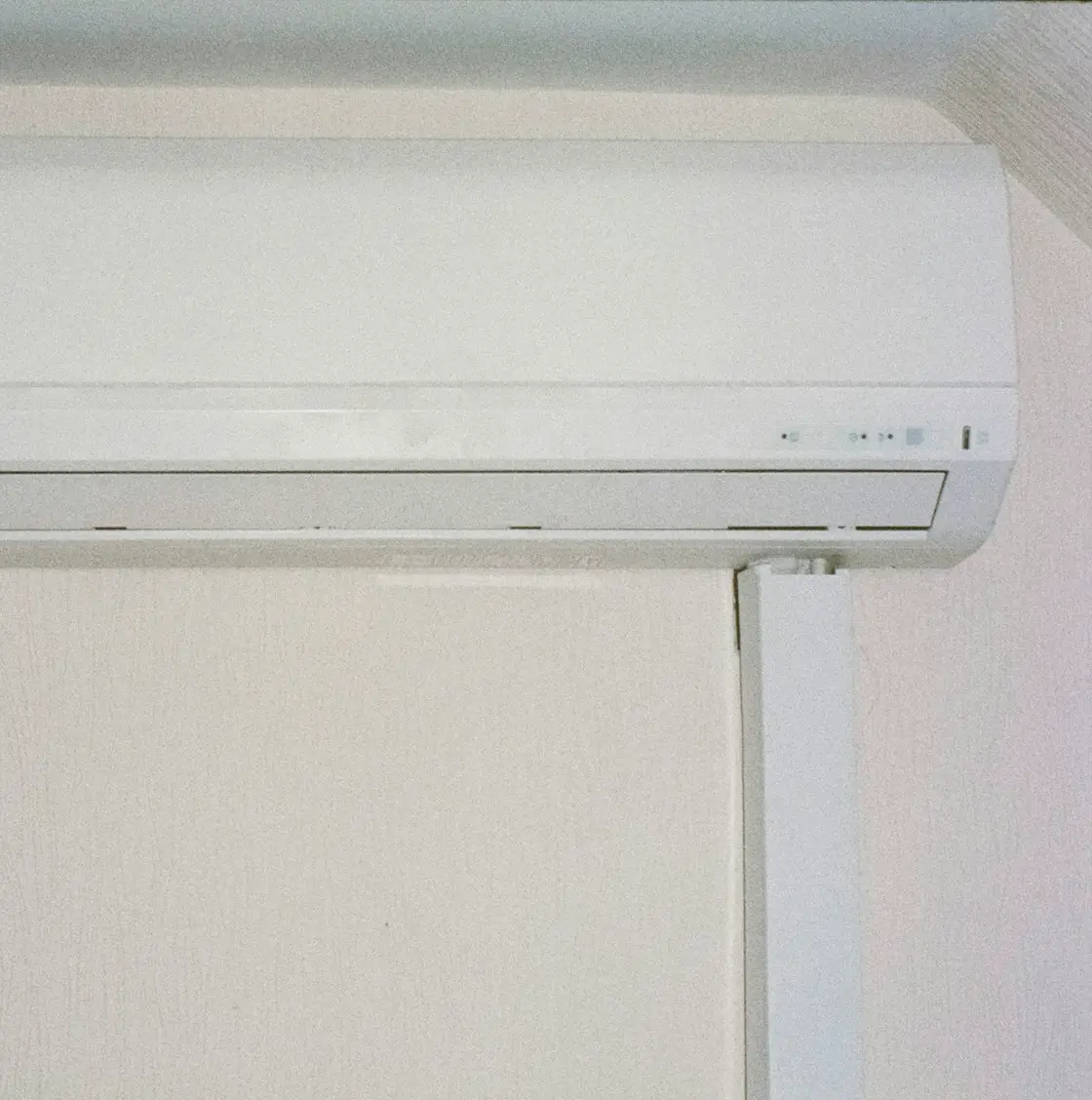 A ductless mini-split indoor unit on a white wall