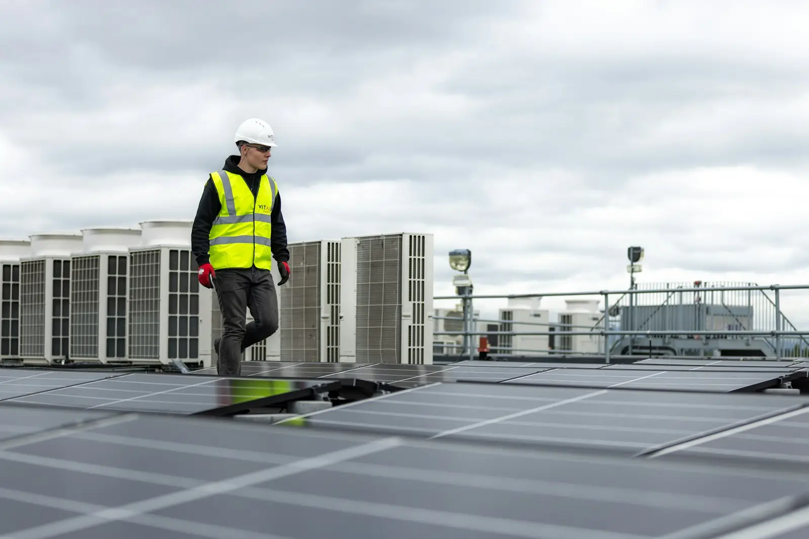 An engineer walking among rooftop mechanical units